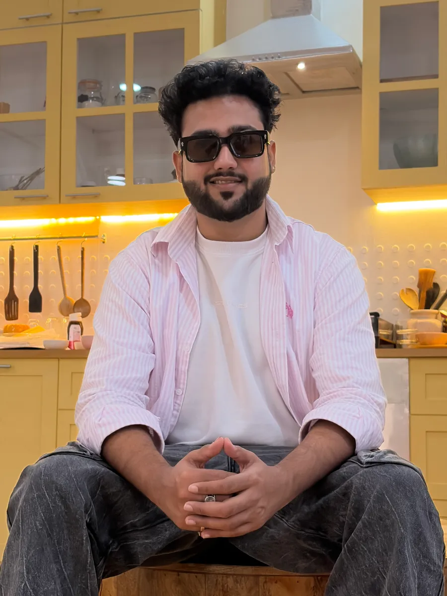 Prashant Mishra, photographed seated on a styled interior set.