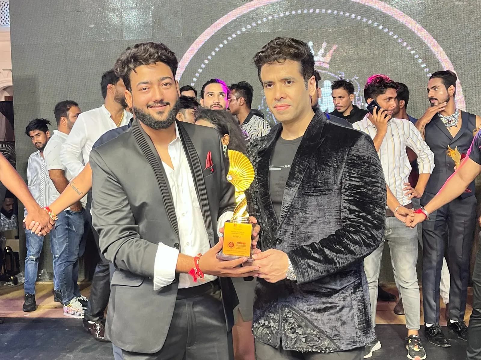 Mishram Media's NUFEW 2024–25 award held on stage at the awards ceremony.