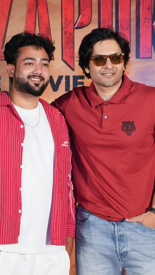 Members of the Mirzapur: The Movie cast in front of the film's poster at its promotional event, from Mishram Media's PR work