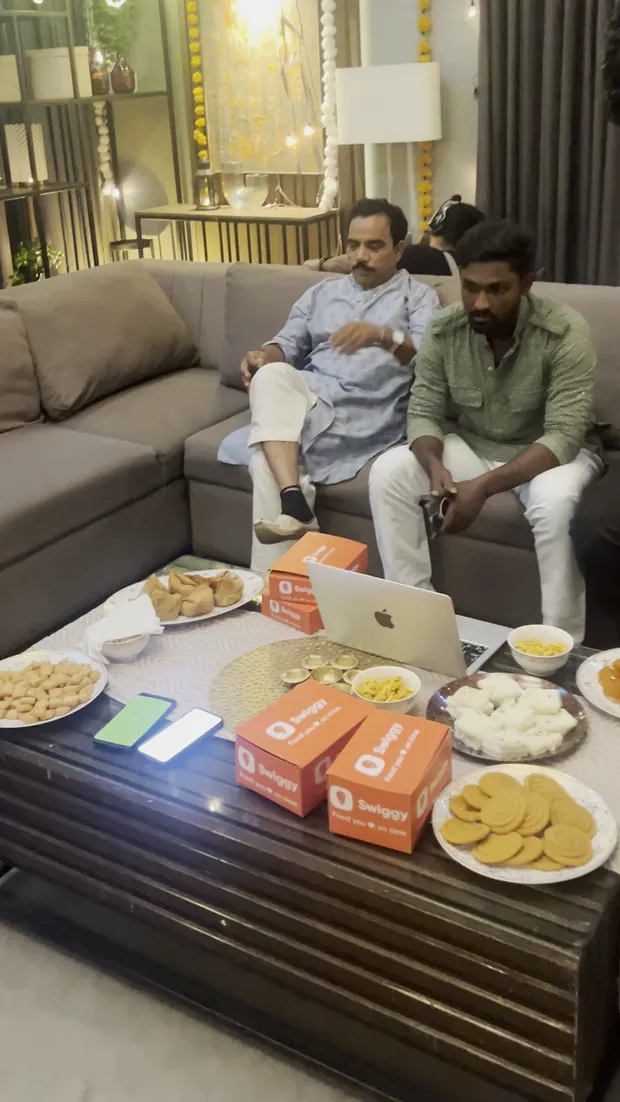 Swiggy delivery boxes and styled food laid out on a table during a content setup, from Mishram Media campaign material